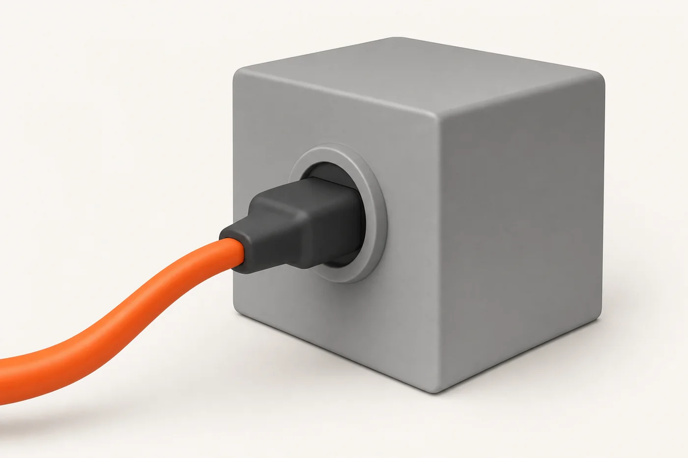 An orange cable with a black plug halfway inserted into a socket on a grey machine block