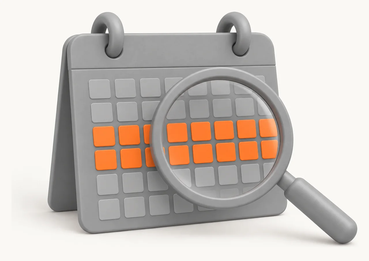 A grey desk calendar with two weeks of days marked in orange, a magnifying glass resting over them